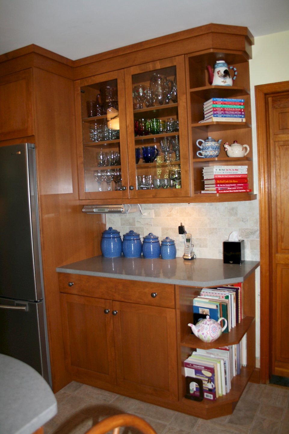 Cabinetry on the refrigerator wall.