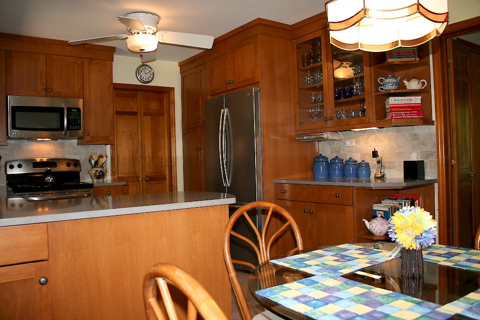 View of the refrigerator and tall cabinetry.