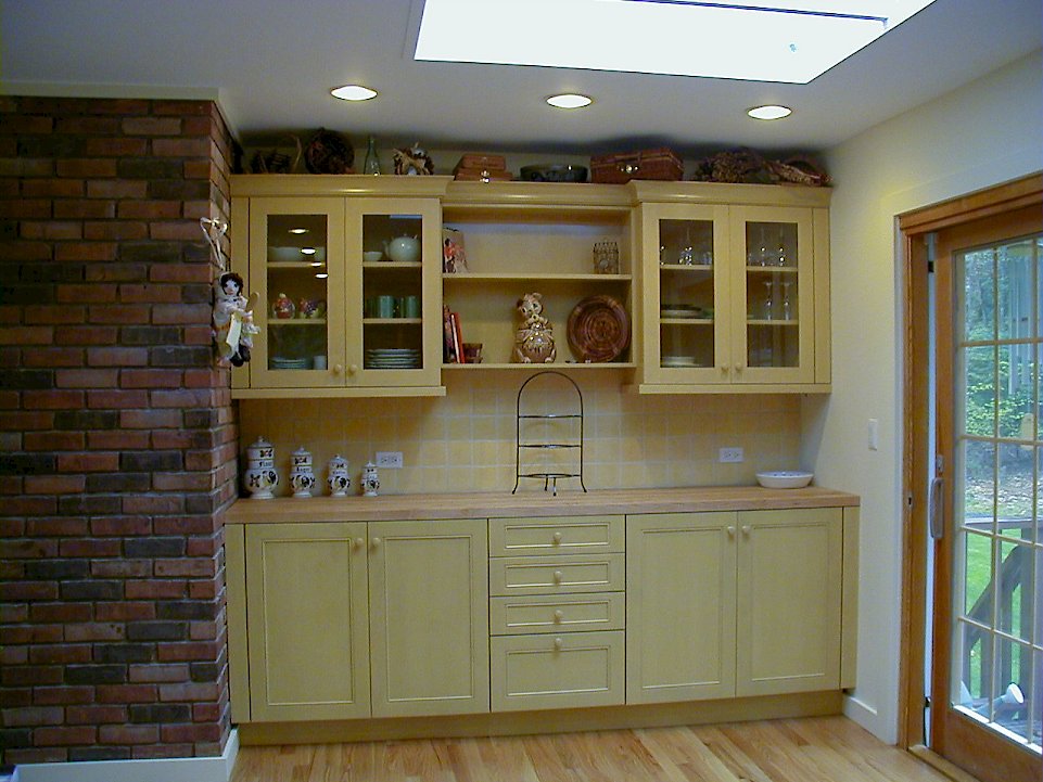 Painted maple cabinetry with a maple wood butcher block top.