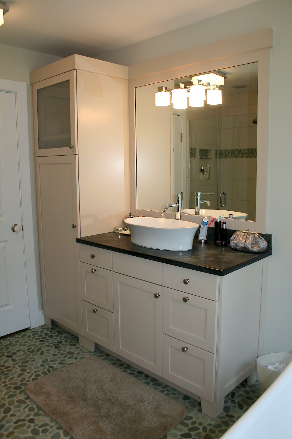 Brookhaven Vanity and tall cabinet with a vessel sink.