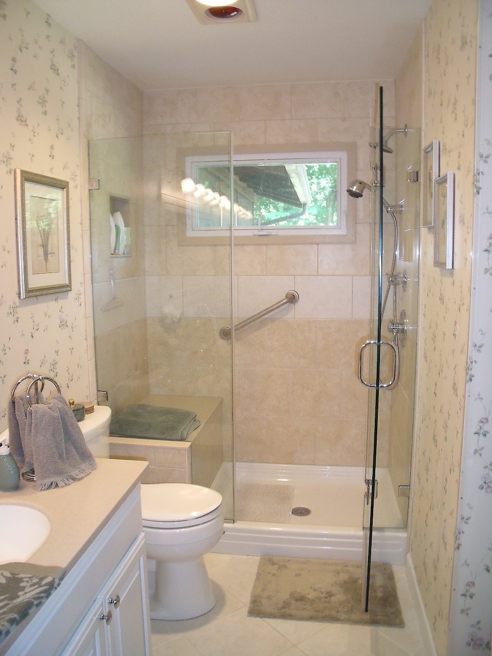 View of the shower with the glass door open.