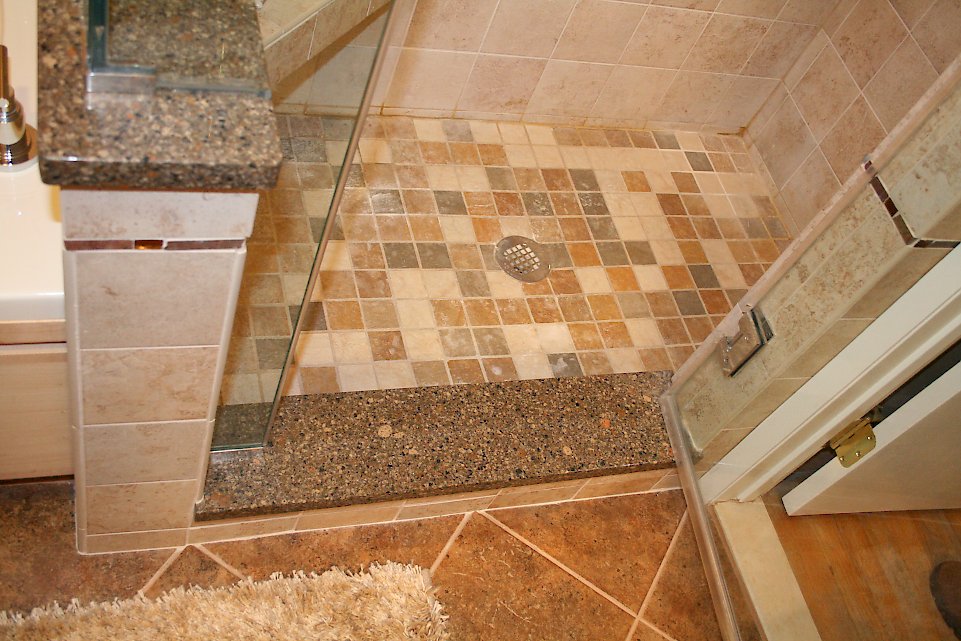 Multicolored tile on the shower floor.