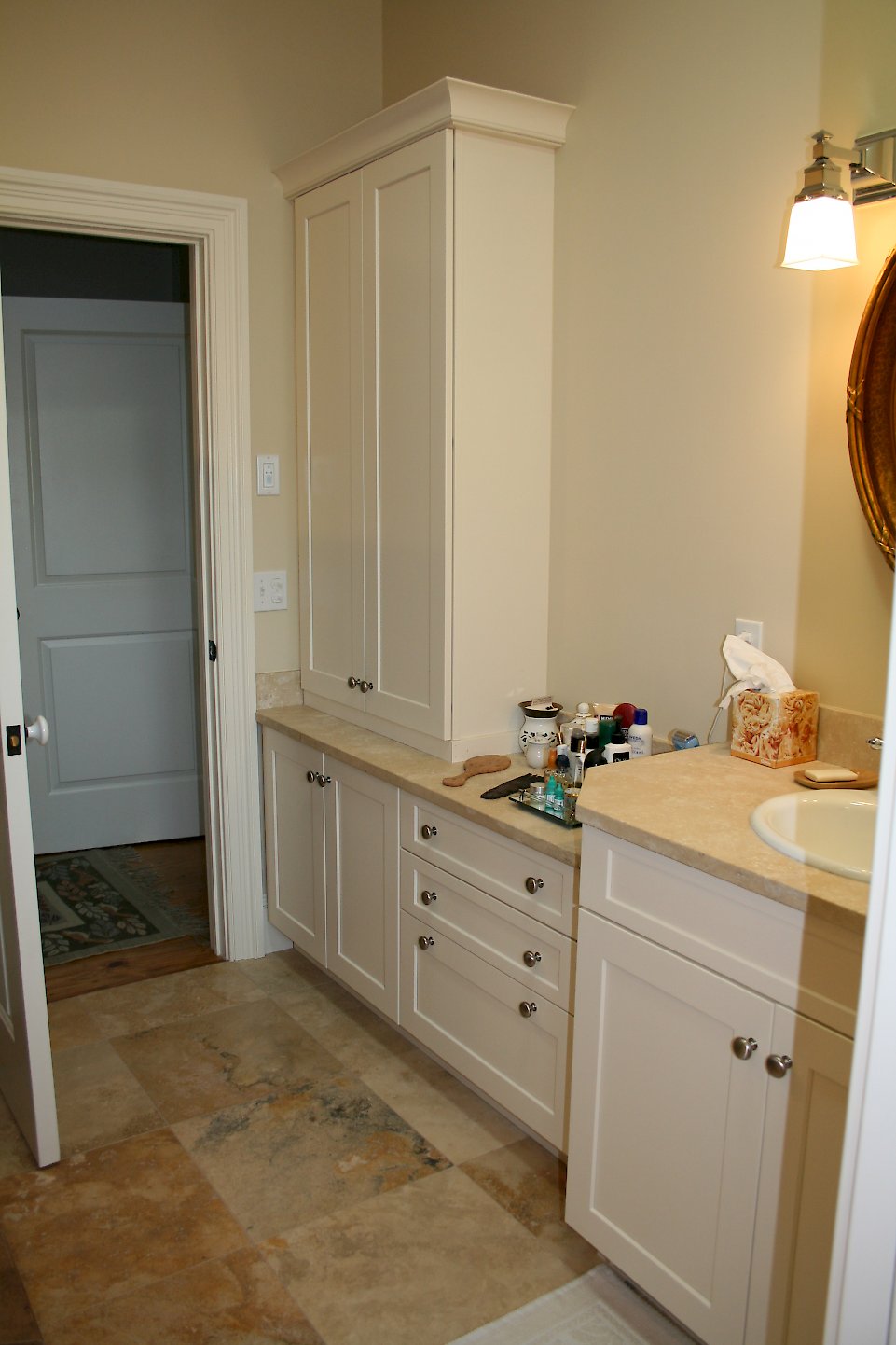 Tall cabinet in the bathroom for towel storage.