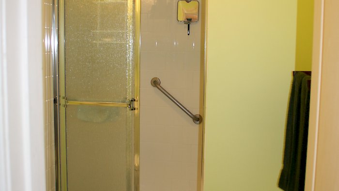 Gold framed shower doors with rain glass.