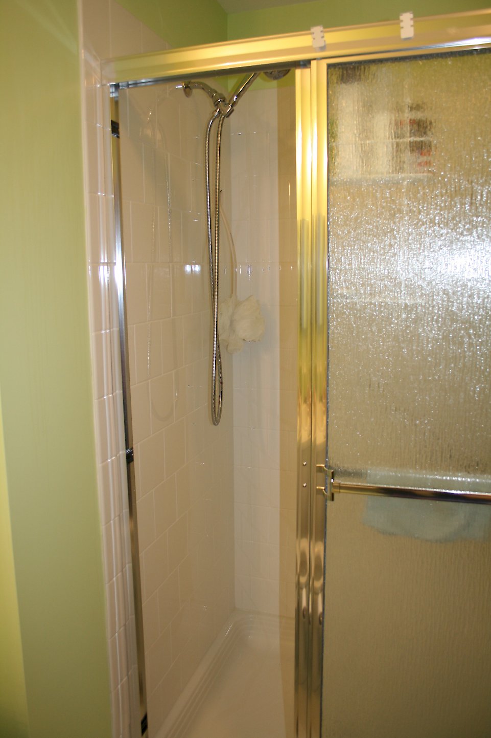 Delta hand shower unit on the main shower wall.