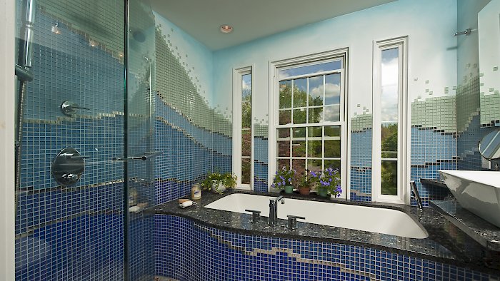 Multi-colored custom tiled bathroom.