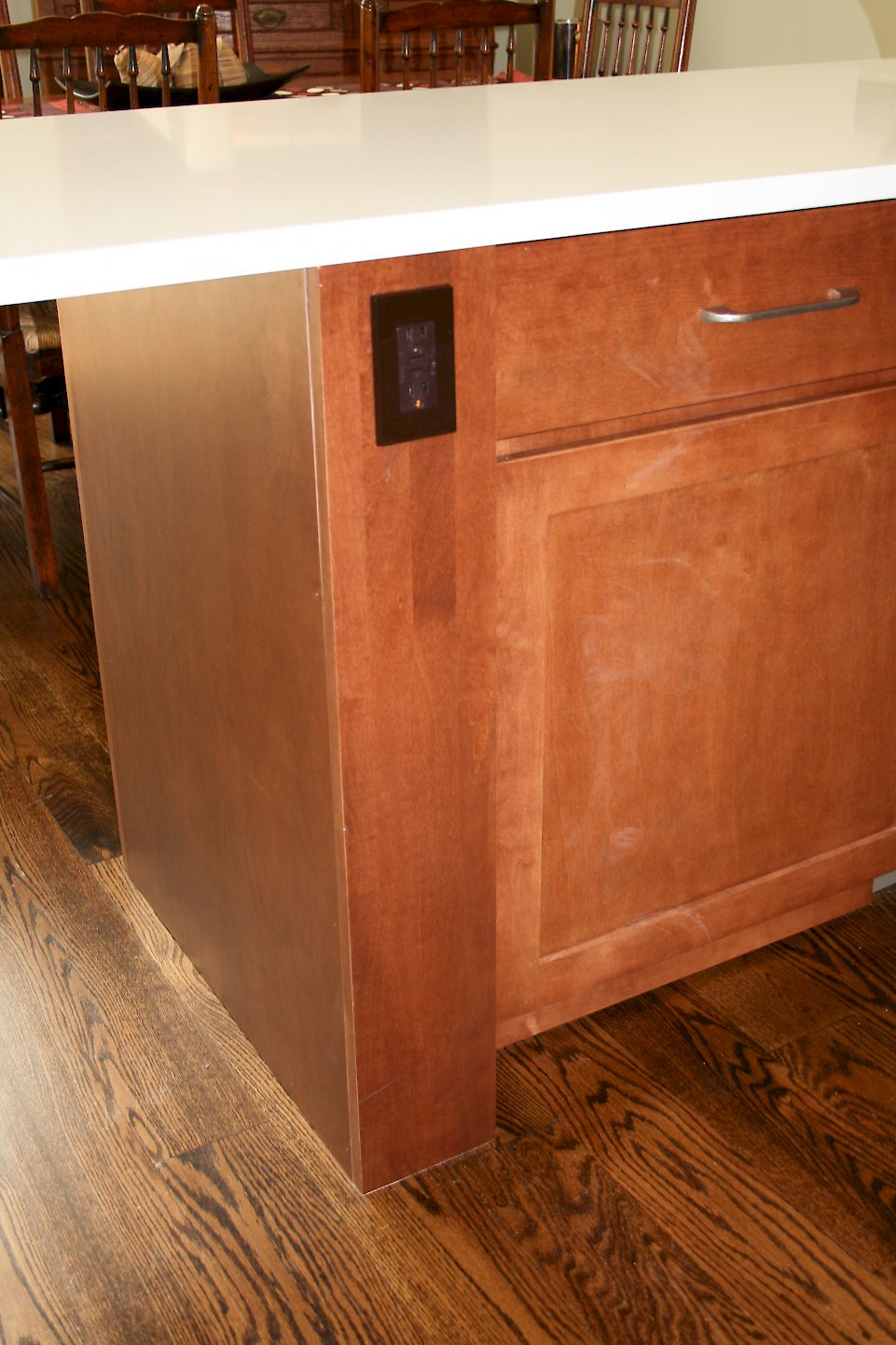 An outlet integrated onto the cabinet frame.