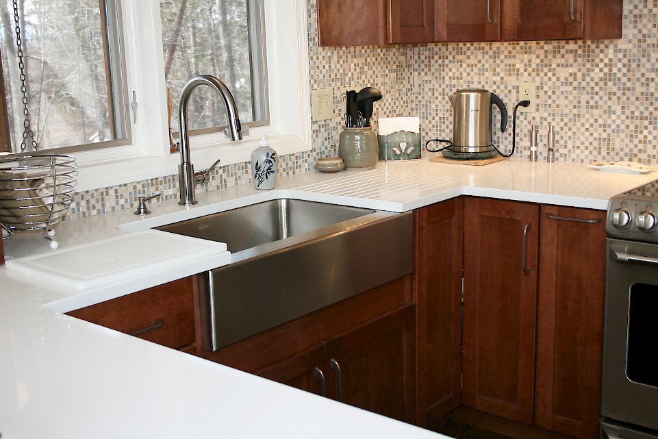 An Elkay farmhouse stainless steel sink.