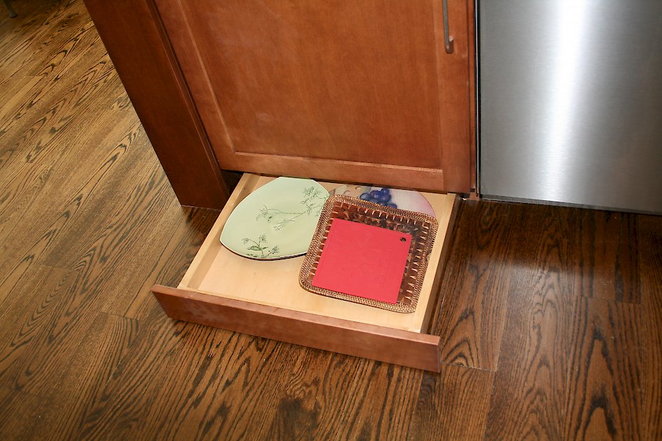 Small drawer next the dishwasher.