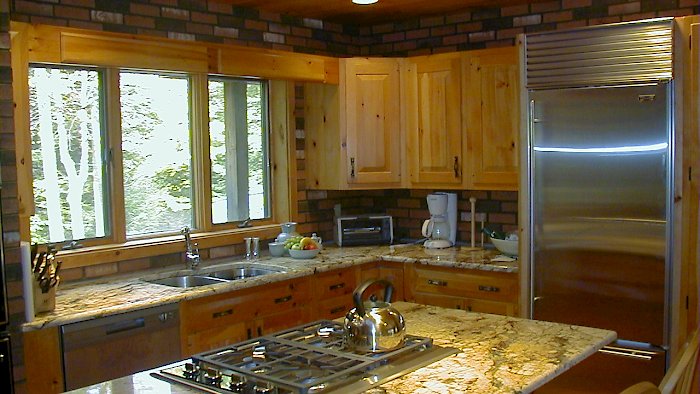 Juperana Persia Dark granite countertops on a rustic pine kitchen.