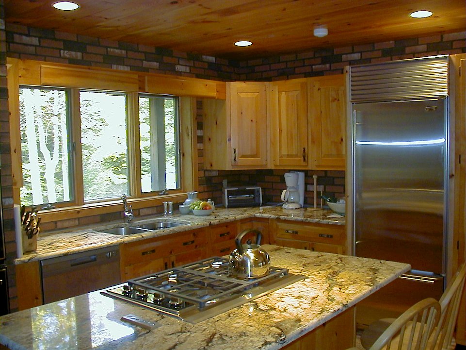 Juperana Persia Dark granite countertops on a rustic pine kitchen.