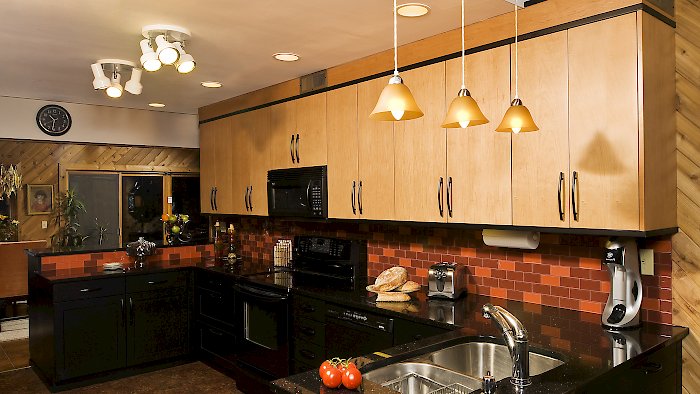 Two toned Brookhaven kitchen with galaxy black granite counters.