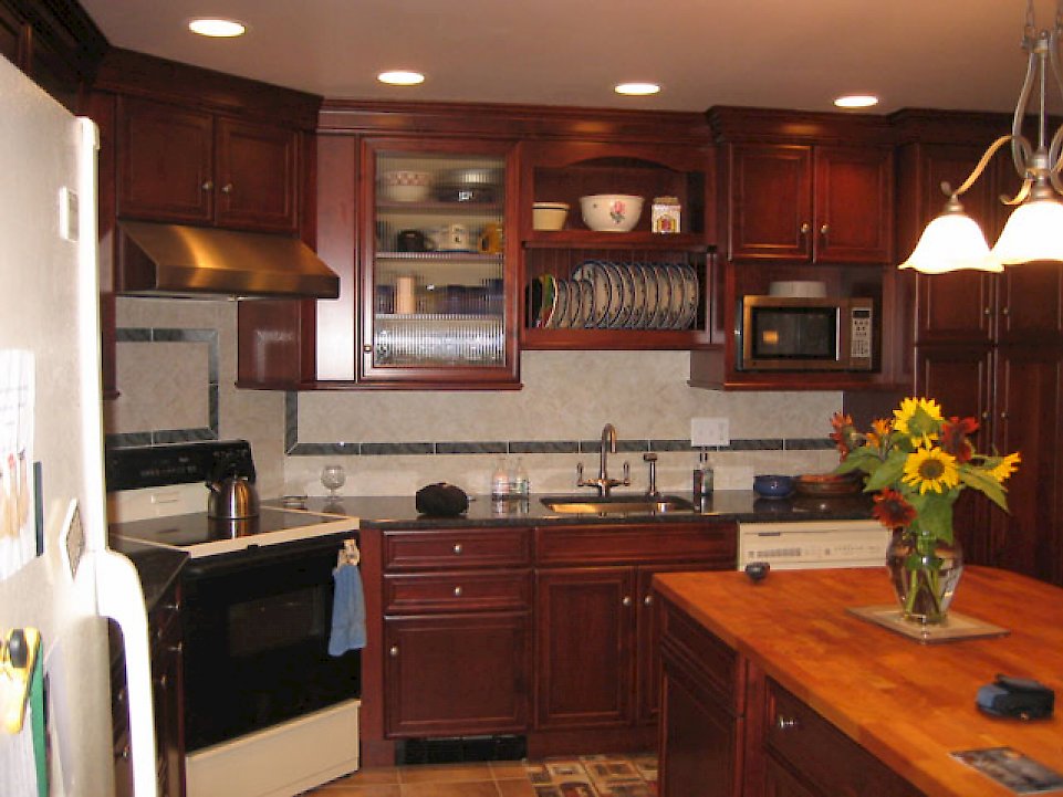 View of the prep sink and plate storage cabinet above.