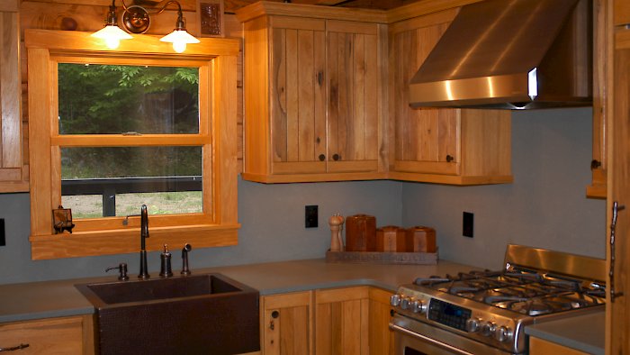 A Medallion Designer Gold hickory kitchen with a custom finish.