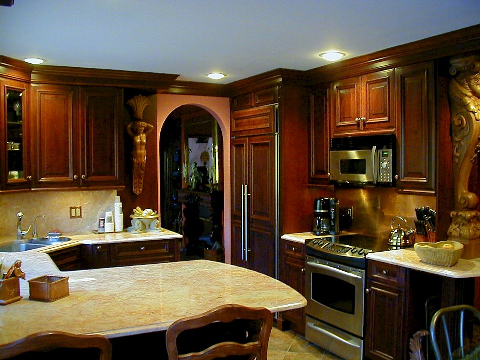 A custom paneled Sub-Zero 561 Refrigerator and Stainless steel GE range.