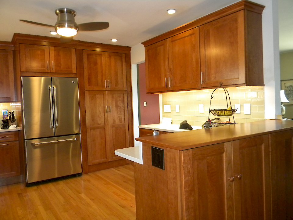 Tall pantry cabinet next to the refrigerator.