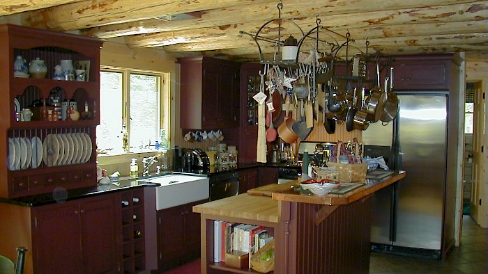 A Wood-Mode kitchen with Sturbridge Inset Recessed door style and Absolute black counters.