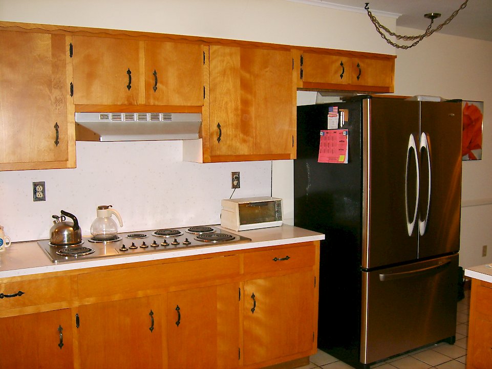 Before picture of the wall with the refrigerator.