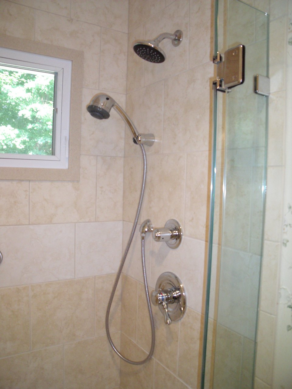 Chrome Delta shower trim with a handshower.