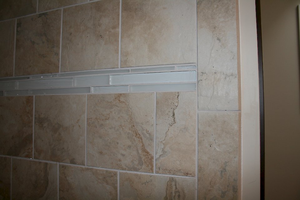 Glass tile accent in the shower.